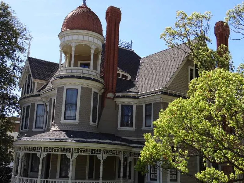 A historic Victorian home with a turret, re-roofed by Sequoia in GAF Grand Sequoia shingles